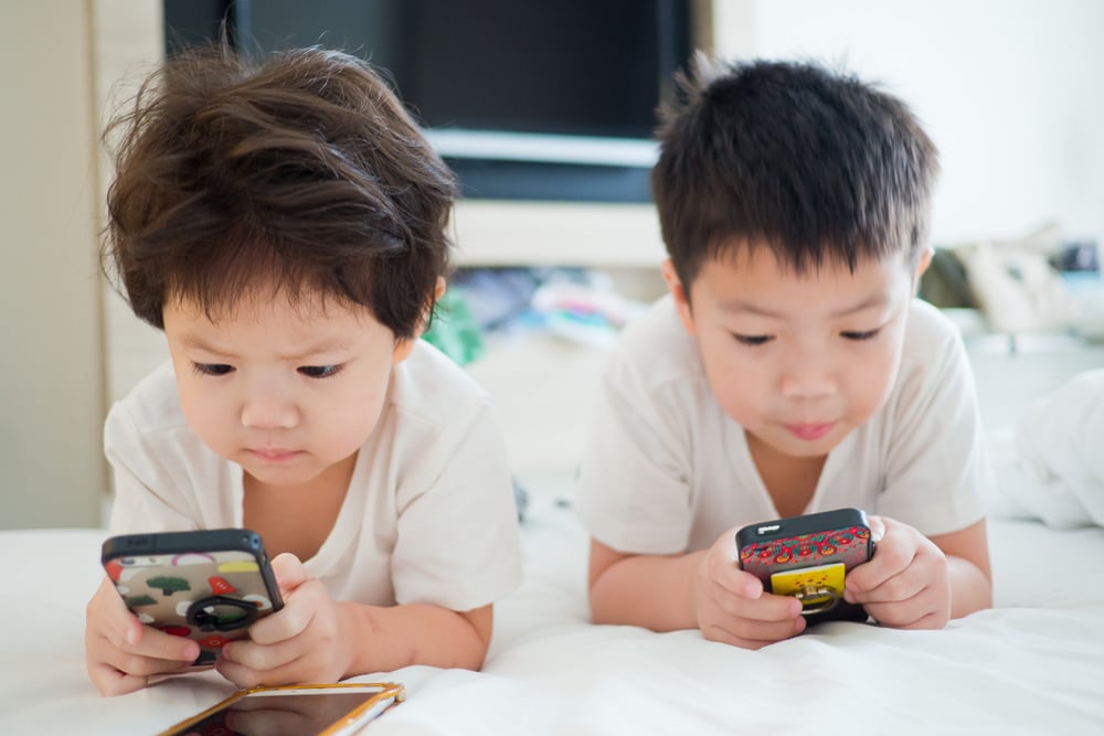 Two boys playing with phones.