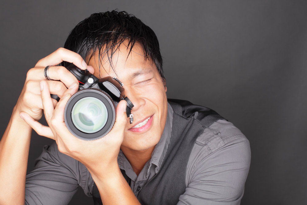 Man holding camera to take pictures.