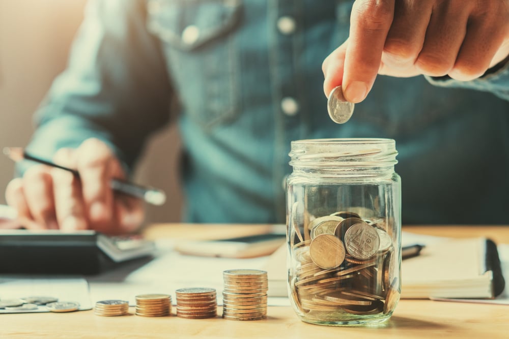 A man calculating his savings.