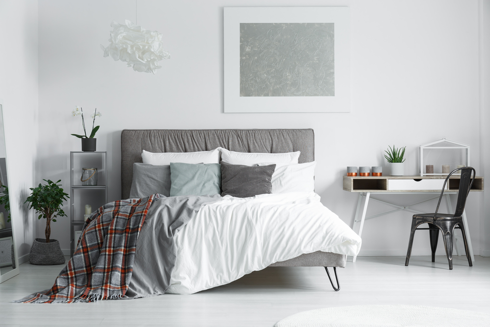 Queen sized bed with pillows and blanket