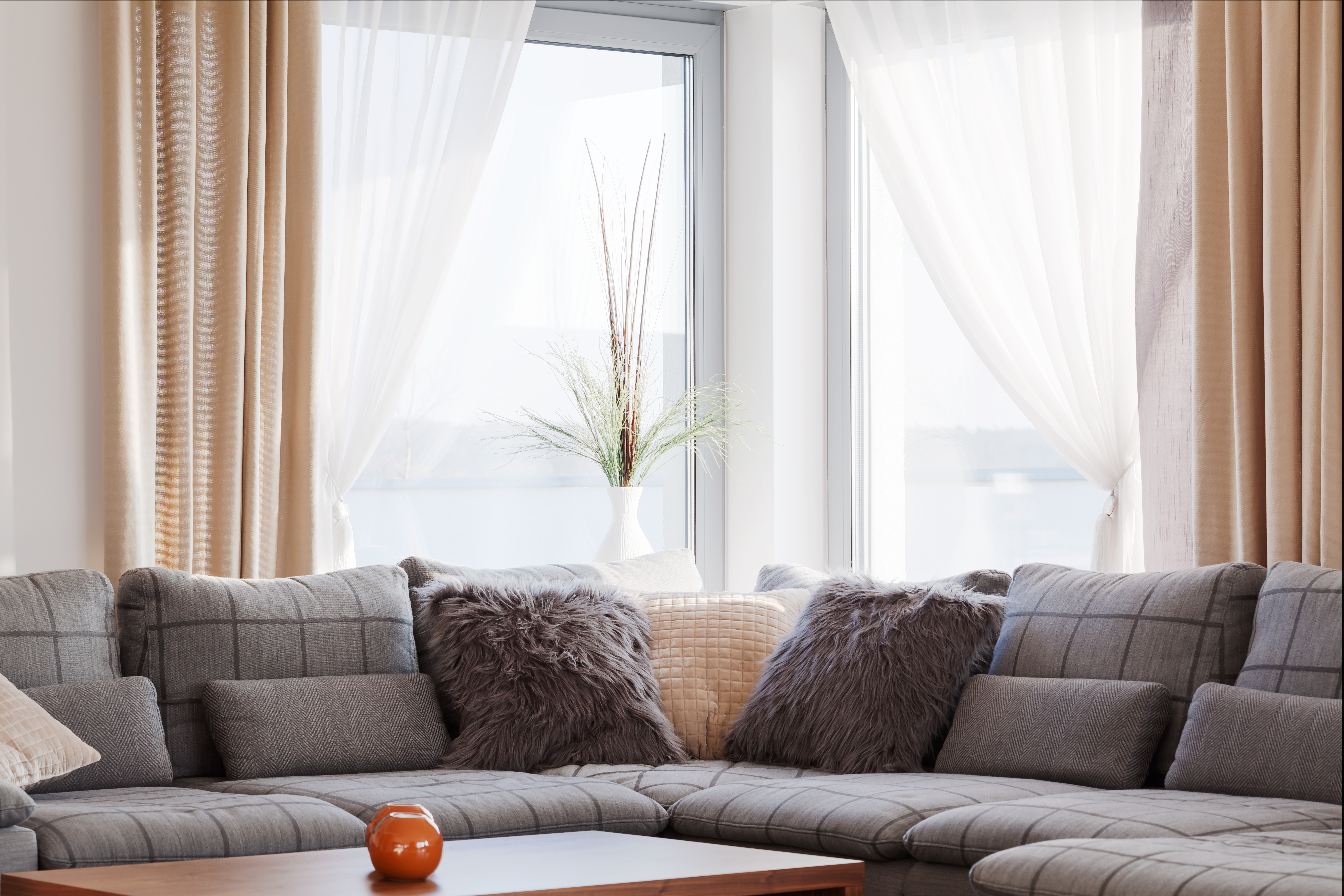 sofa set in a living room with pillows and coffee table