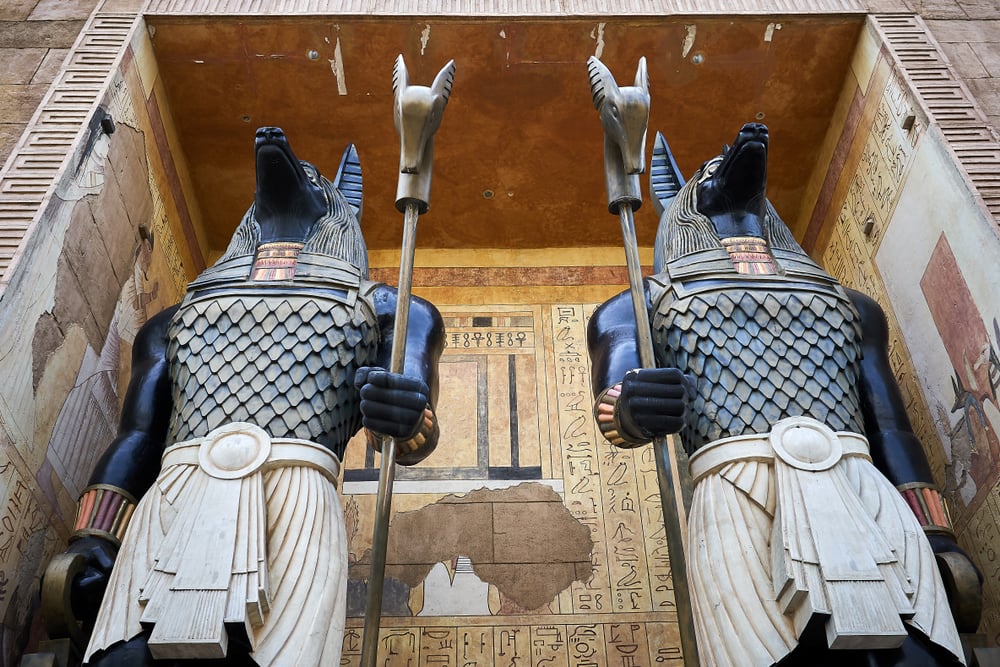 Two tall Egyptians god Anubis statues.