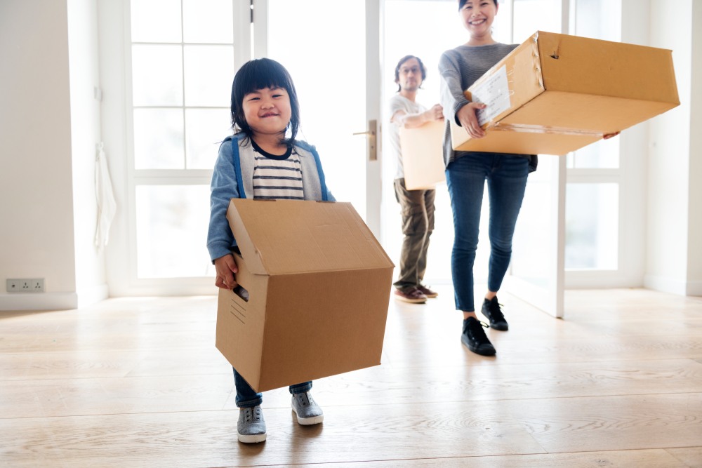 family carry boxes and moving out