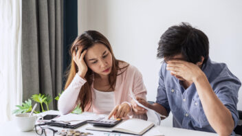 a couple stressed over finances and housing affordability