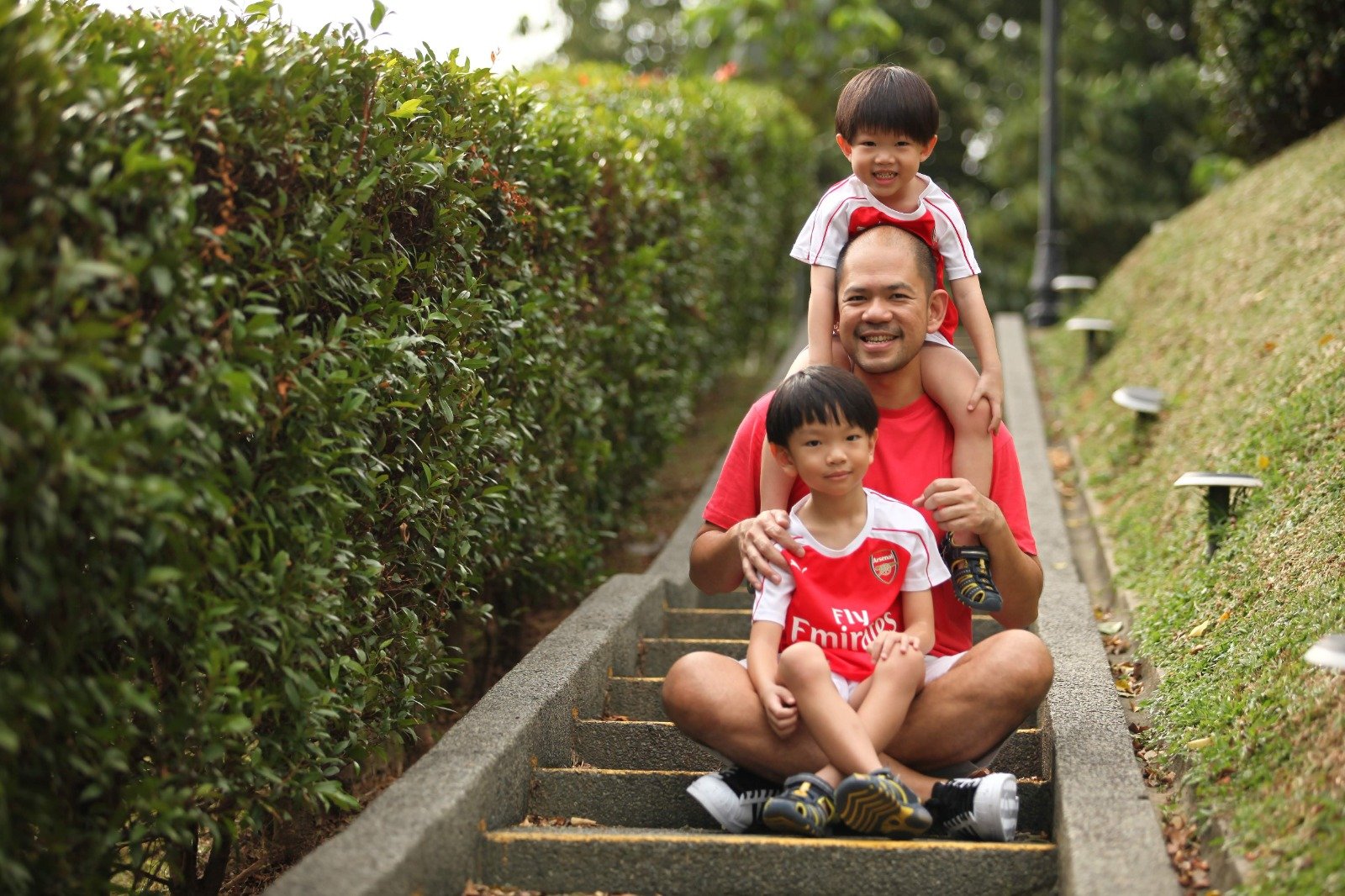 father and sons on steps outdoors