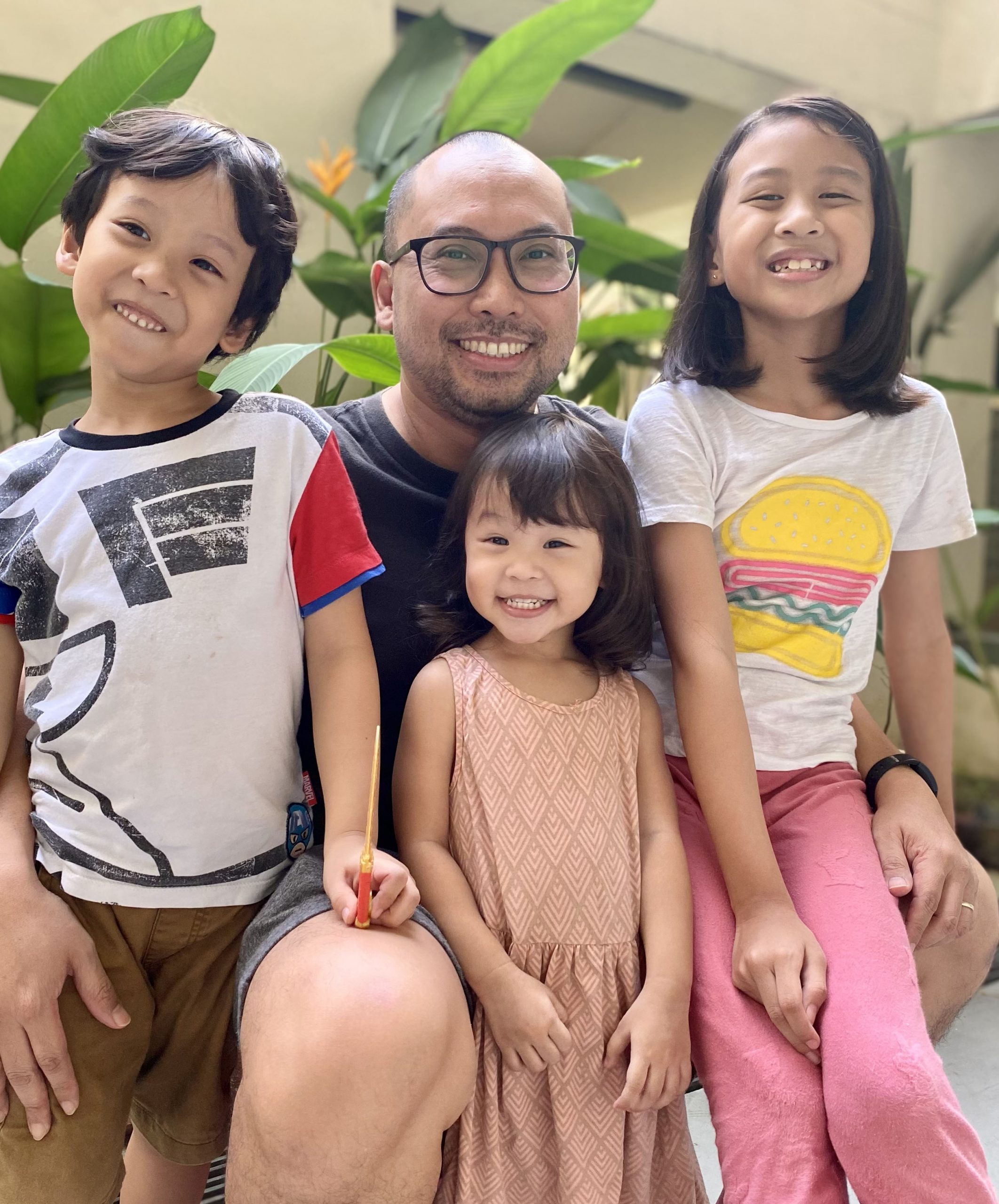 father with his three children at their front porch