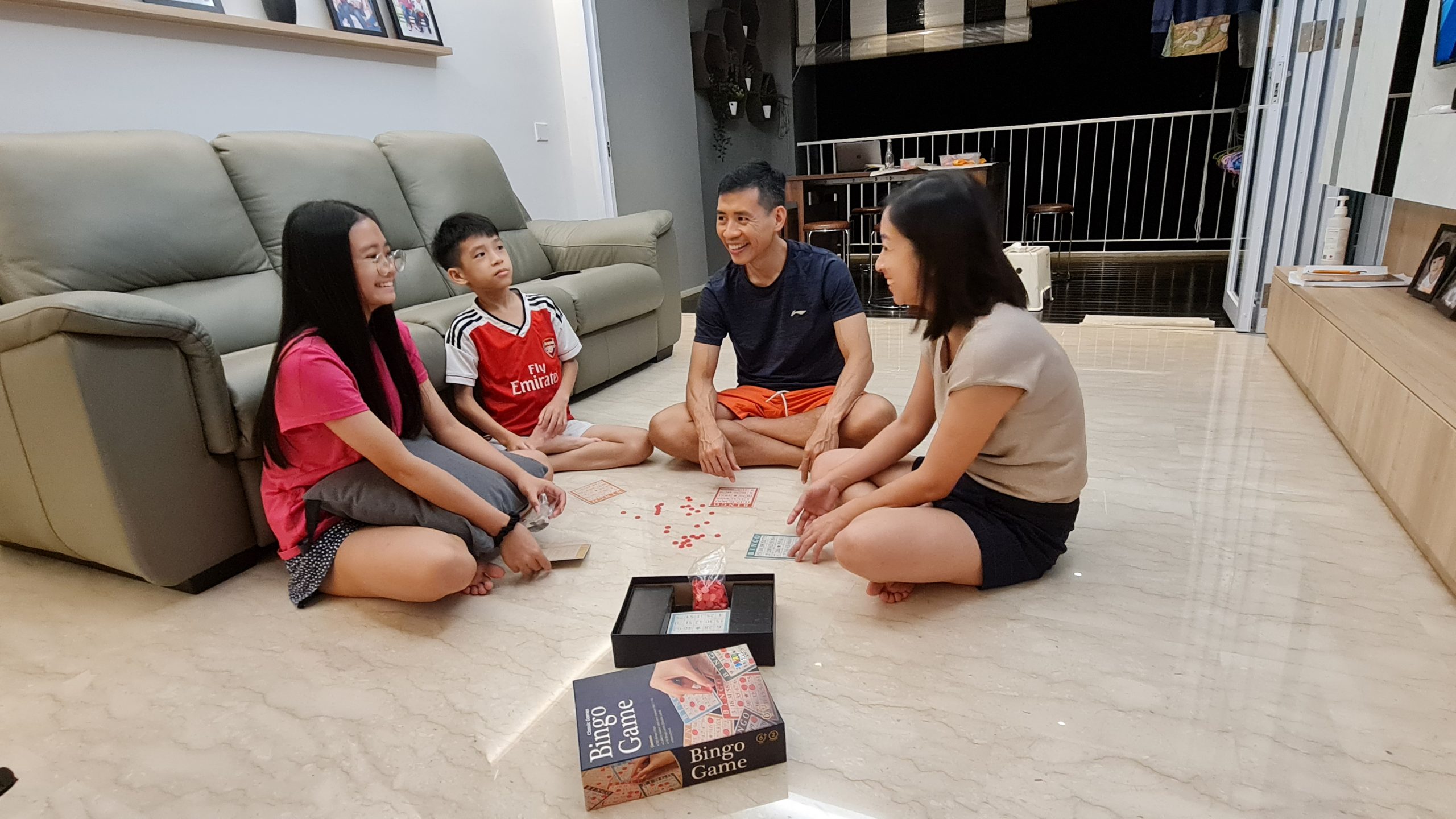 father playing a boardgame with his wife and children