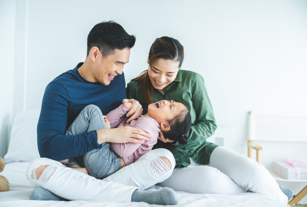 A couple playing with daughter