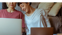 lqbtq same sex couple at home on computer