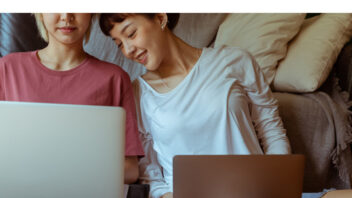 lqbtq same sex couple at home on computer