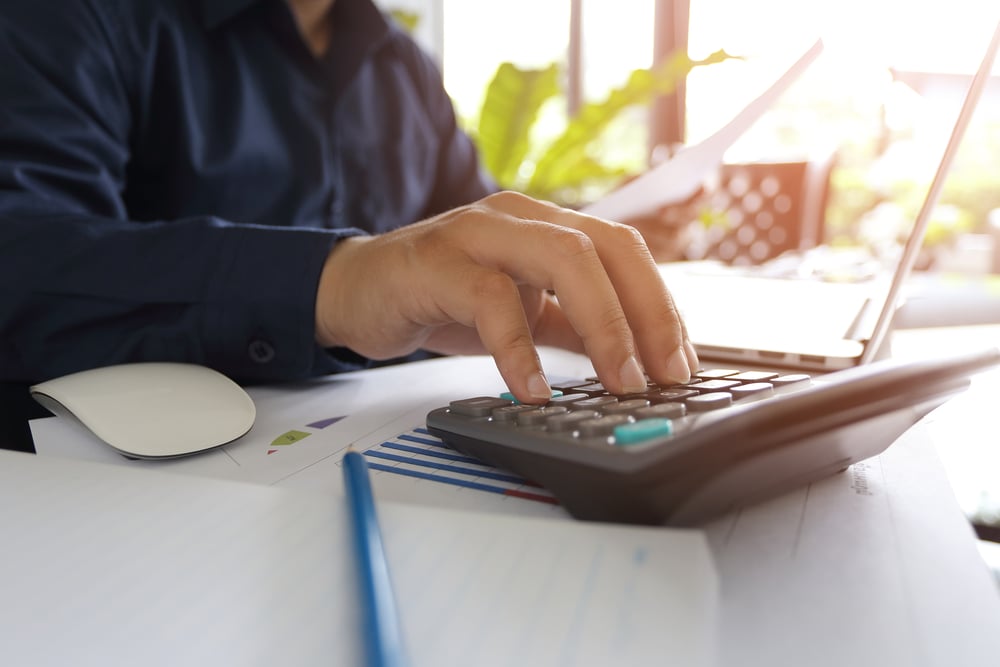 Person calculating his finances to pay for executive condo