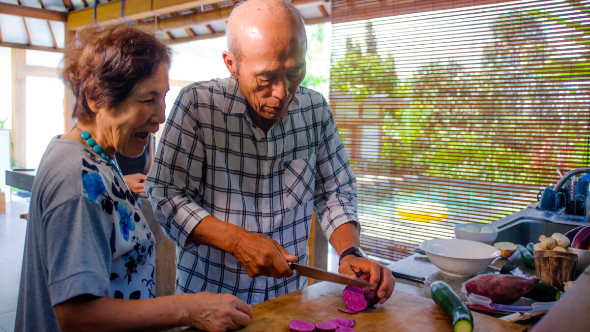 Seniors retirees preparing food in their home kitchen