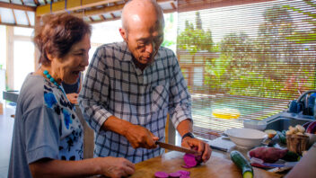 Seniors retirees preparing food in their home kitchen