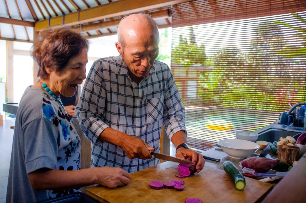 Seniors retirees preparing food in their home kitchen