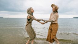 Older gay LGBTQ couple female on the beach
