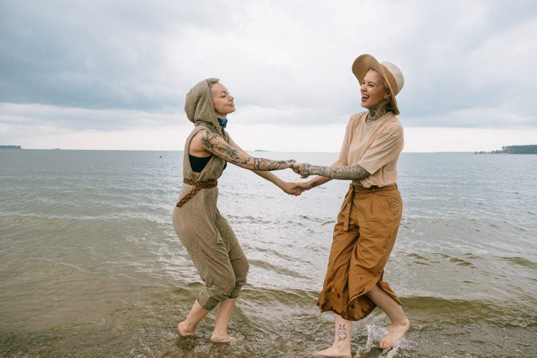 Older gay LGBTQ couple female on the beach