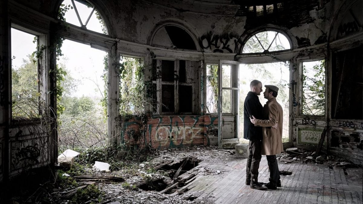 Middle age gay LGBTQ couple in an abandoned house