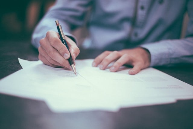 A man signing an agreement