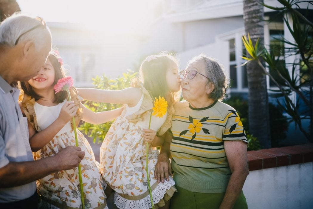 Senior elderly couple outdoors with grandchildren