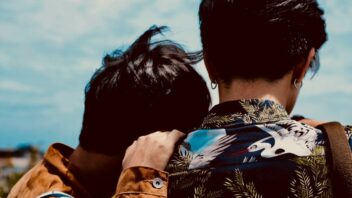 LGBTQ+ gay couple back facing