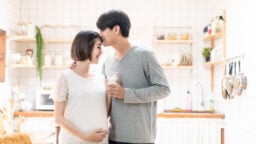 Asian couple pregnant in new home