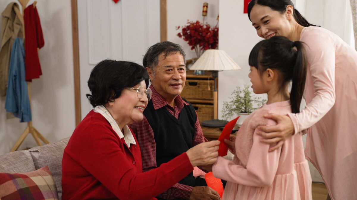 Senior elderly couple ang pow grandchildren Chinese New Year