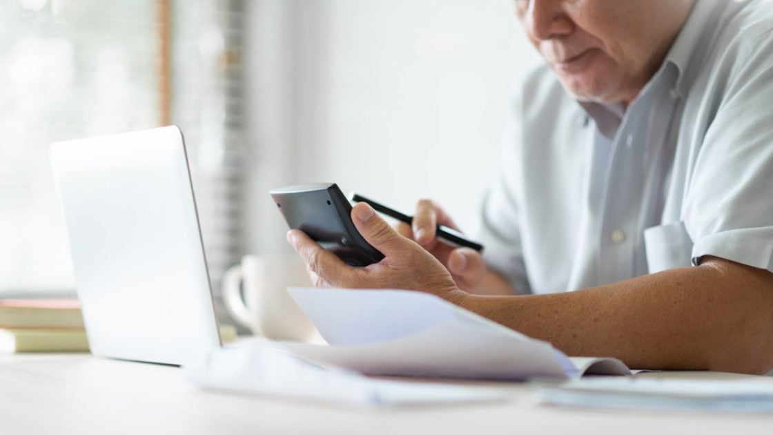 Old man using calculator