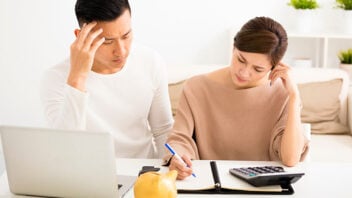 couple researching and calculating finances