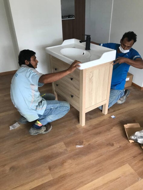 Workers sealing down the sink