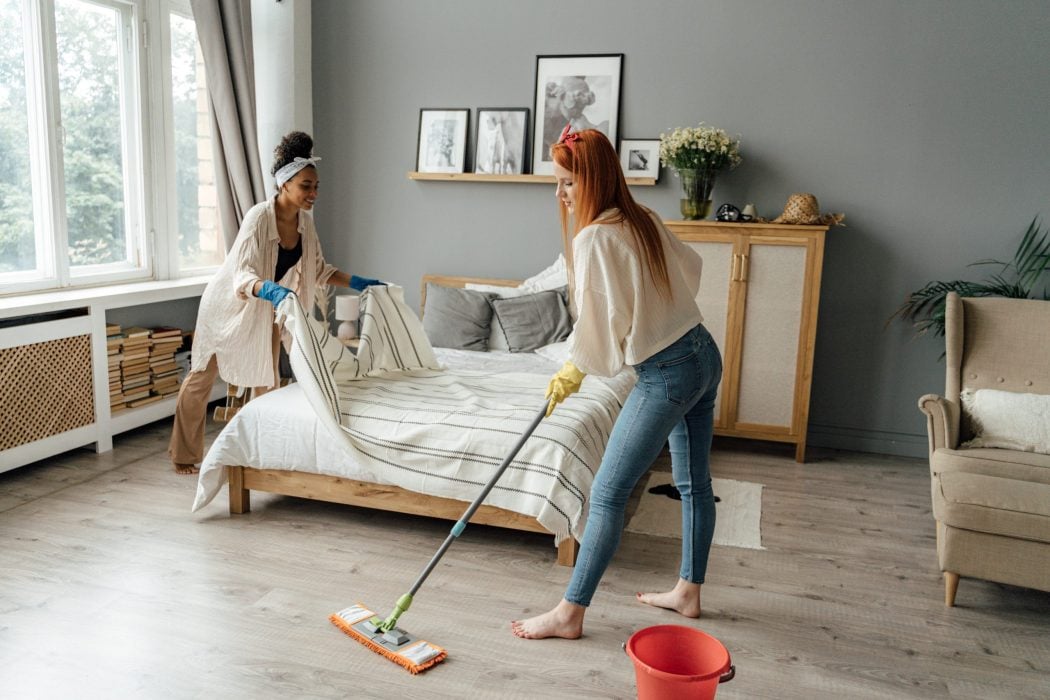 two women cleaning their rented aparttment furnishing