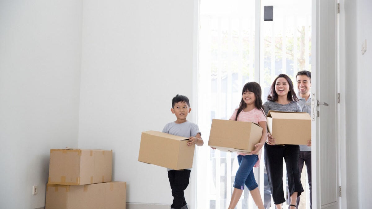 family bringing boxes and moving house