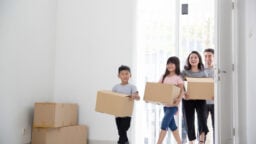 family bringing boxes and moving house