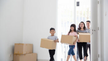 family bringing boxes and moving house