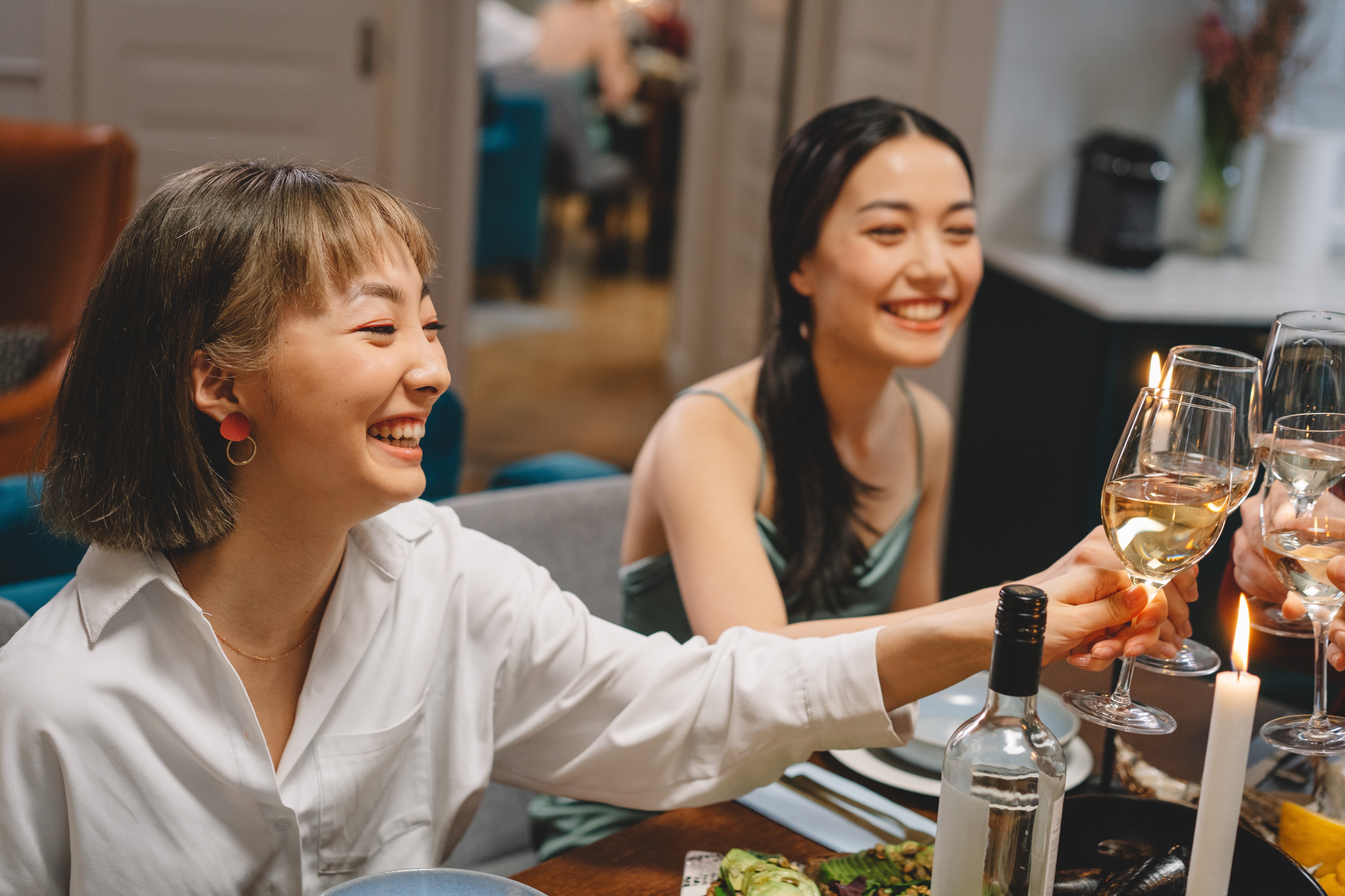 A social moment with people clinking their wine glasses together - home decoration tips