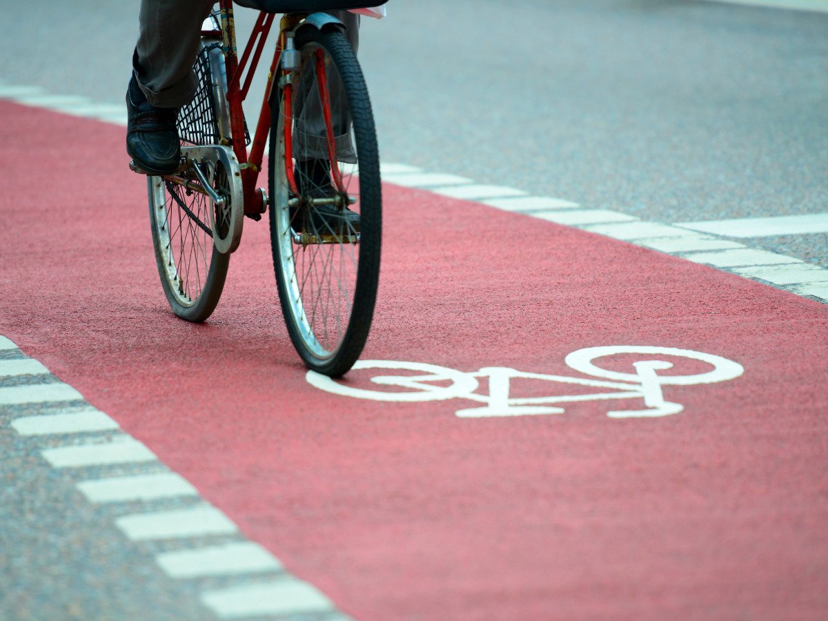 person riding bicycle on cycling pathway