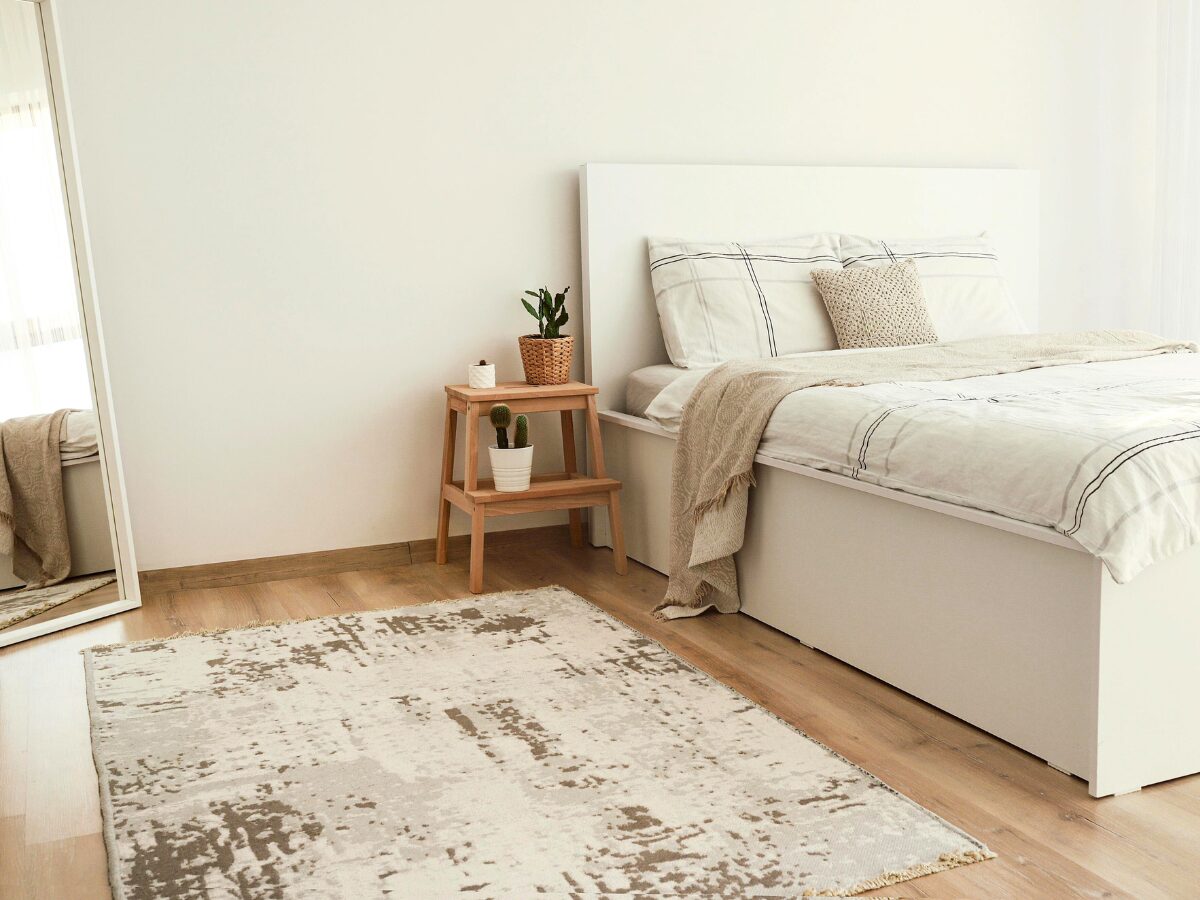 scandinavian hdb room designs with velvet rug and a large mirror.