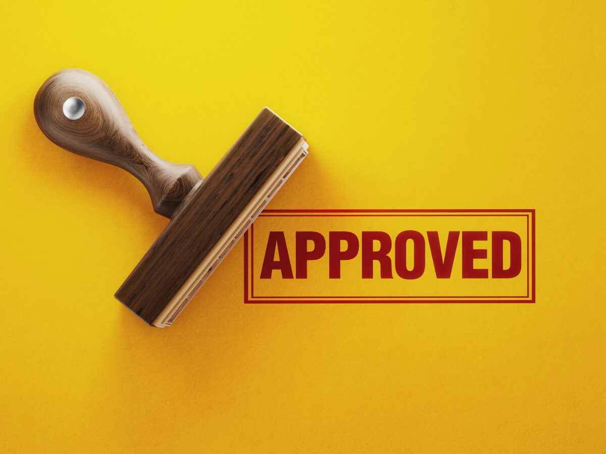den Approved Stamp On Yellow Background 