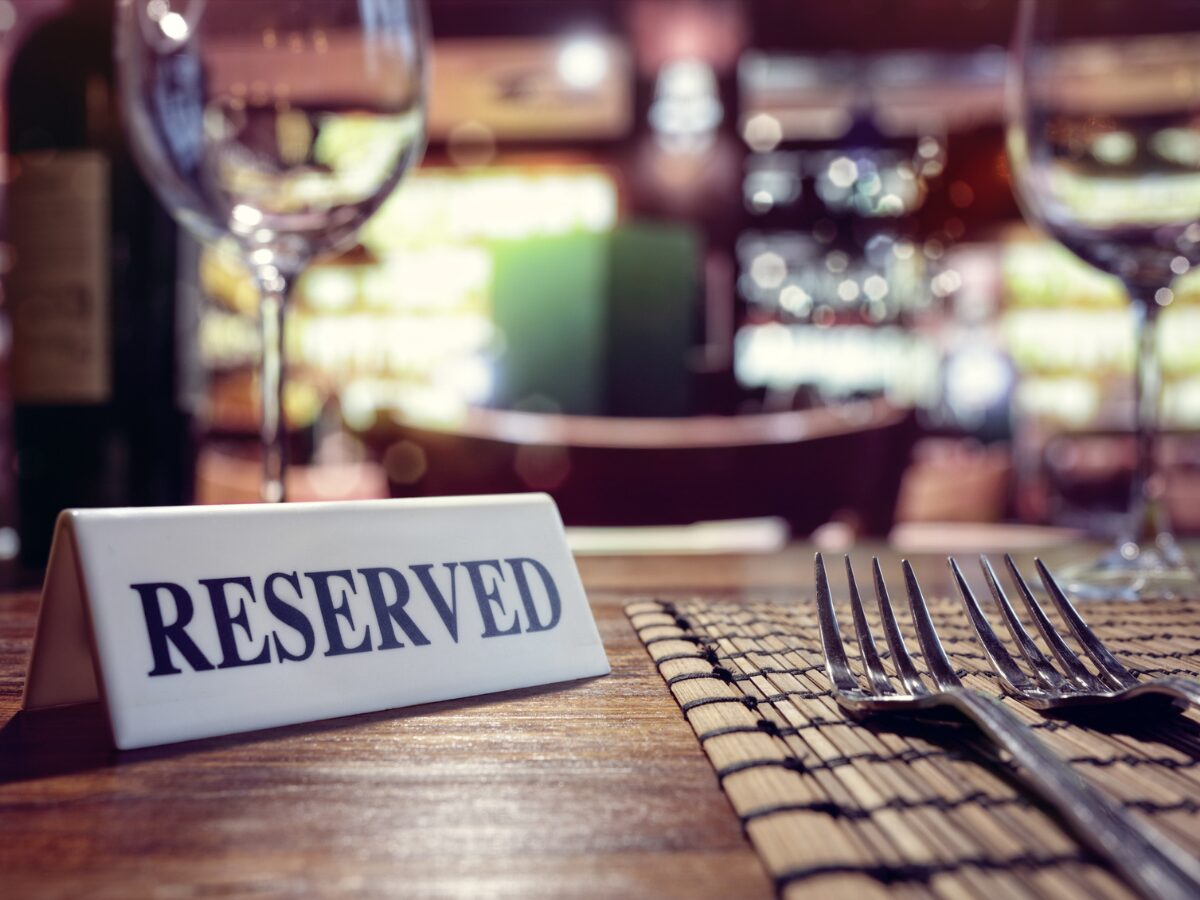 eserved sign on restaurant table with bar background 