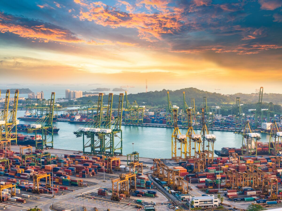 Container Cargo freight ship with working crane bridge in shipyard in singapore